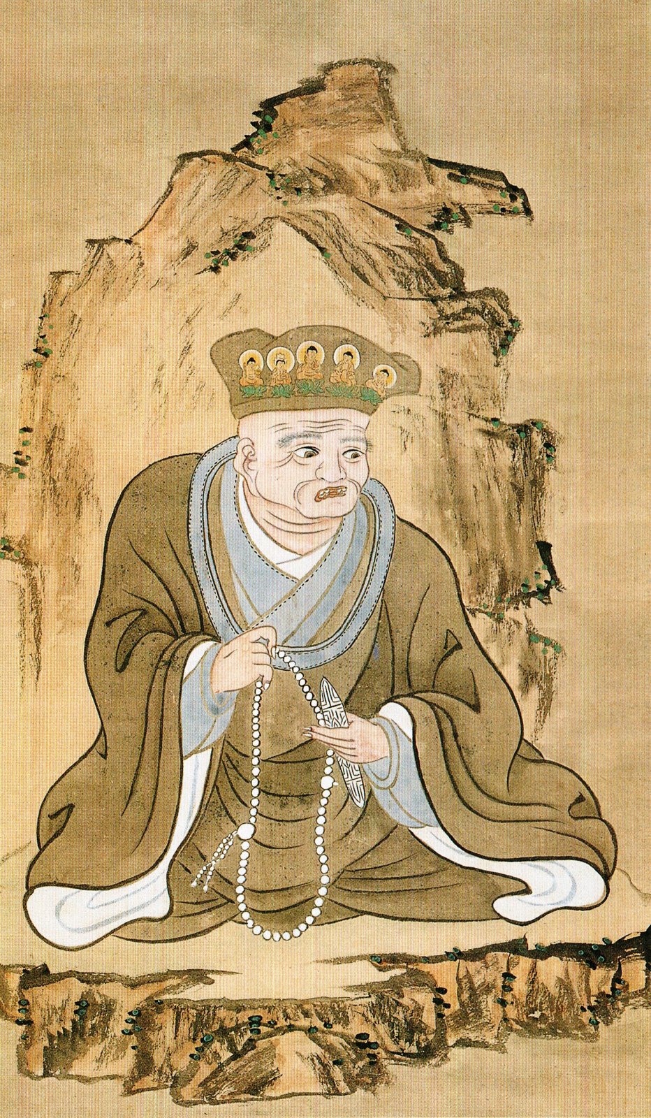 1805年（文化2年）に大森旭亭が描いた円空像。五体の仏を付けた帽子をかぶり、数珠と刃物を手にしている。没後110年の絵